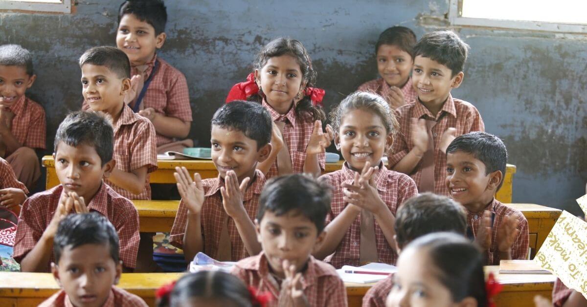 Happy, cheering kids learning at school in a developing country