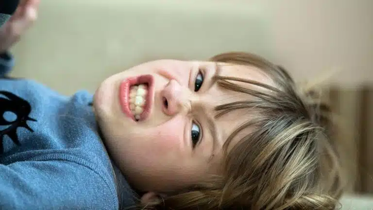 aggressive child laughs when hurting others