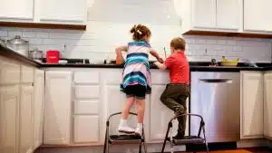 children helping their parents at the kitchen