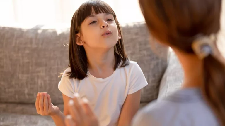 An image of a girl talking to her mother, bilingual child