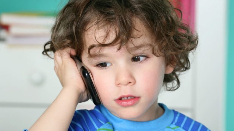 a toddler speaking on the phone